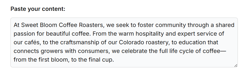 Screenshot of the AI Visibility Grader input field with content from Sweet Bloom Coffee Roasters’ About page. The text highlights the brand’s focus on community, craftsmanship, and education in the coffee lifecycle.